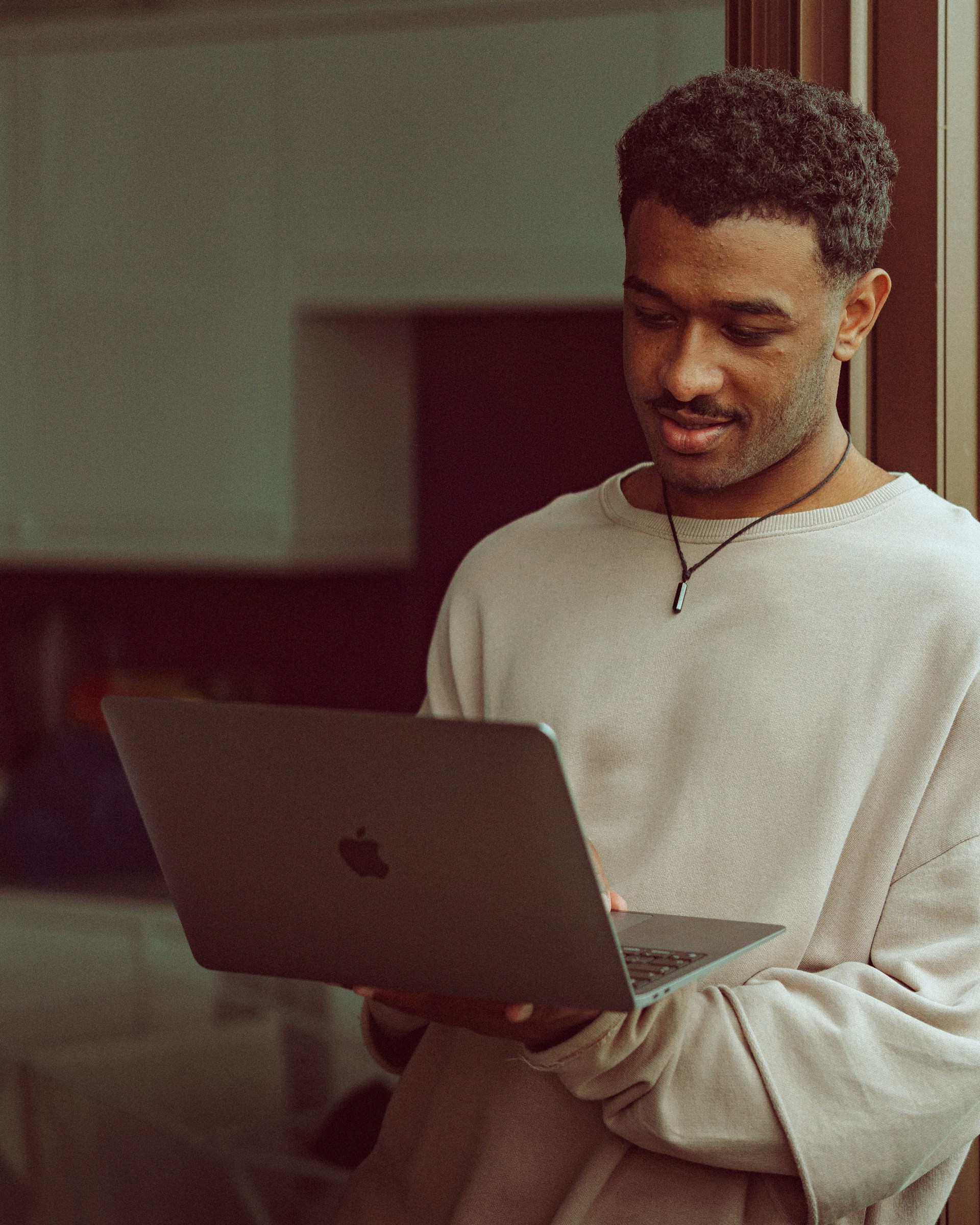 Station owner reviewing records on laptop